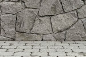 Close-up of textured stamped concrete wall and stone-patterned surface showing realistic design detail in Brunswick OH.